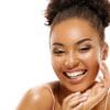 Young African American woman smiling and touching her healthy skin